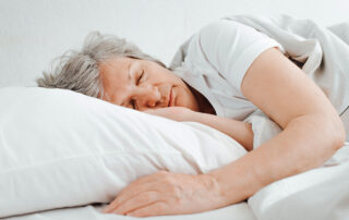 Senior Caucasian Woman Sleeping In Comfortable Bed, Relaxing In